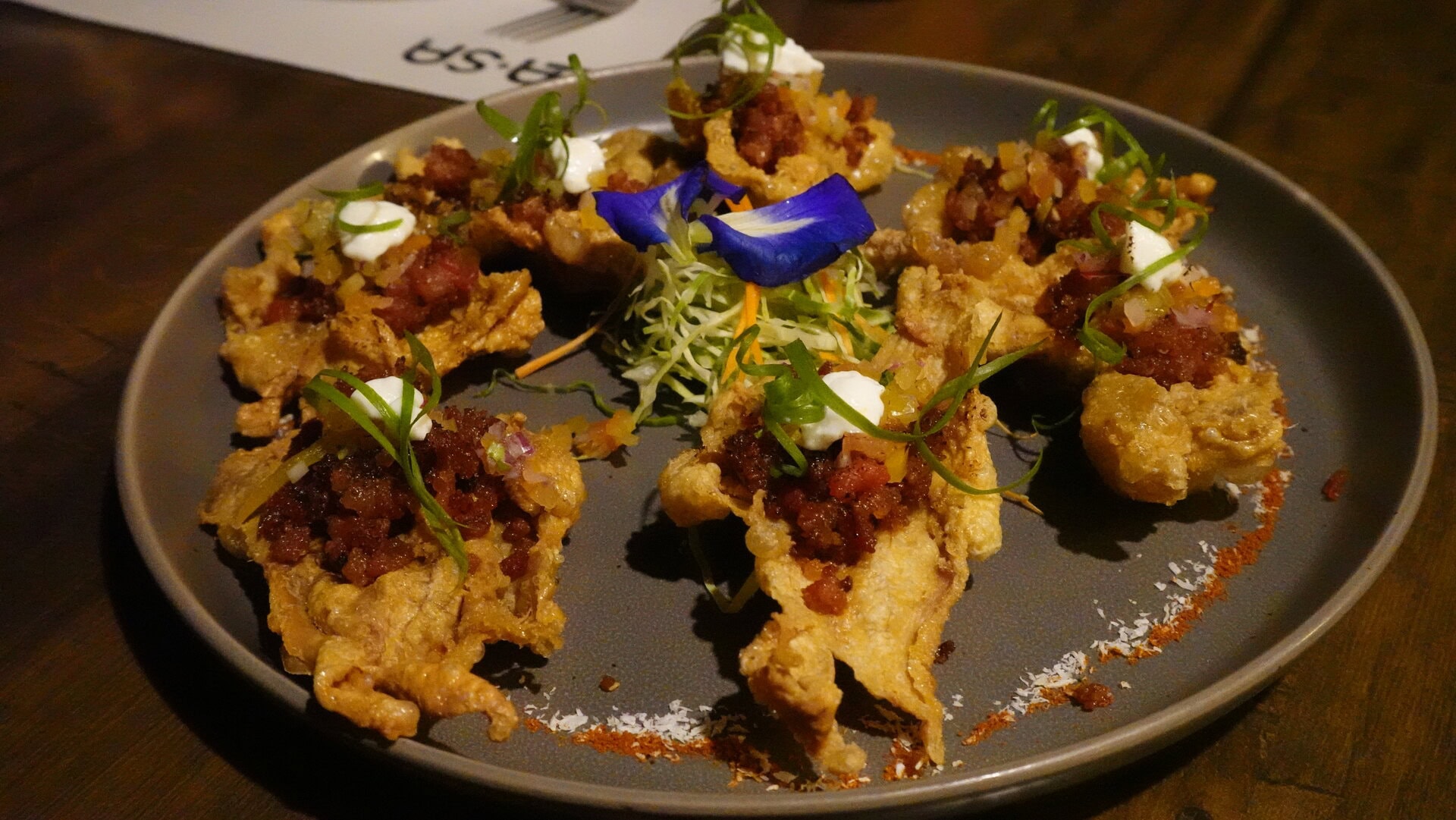 カリッとした鶏皮をトッピングにしたユニークなフィリピン×メキシカン。390ペソ（約￥1,030）。