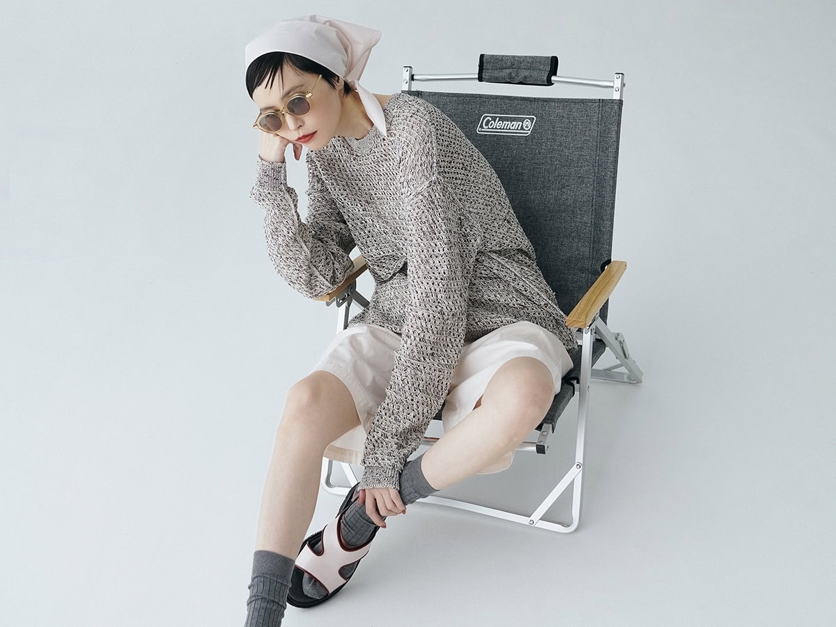 チェア〈コンパクトフォールディングチェアNX〉¥9,900（コールマン／コールマン カスタマーサービス）、ニット¥39,600（ヨーク／エンケル）、パンツ¥28,600、スカーフ¥15,400（共にLittle $uzie Apartment Tokyo）、サングラス¥55,000（カーニー／ソスト）、ソックス¥3,630（パンセレラ／真下商事）、靴¥88,000（アデュー／バウ インク）、インナーはスタイリスト私物