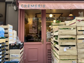 向かいの八百屋さんの品出し前の野菜に、埋もれてしまったチーズ屋。